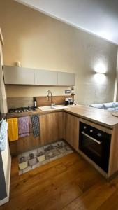 a kitchen with a sink and a stove at Casetta Valle Verde in Capalbio