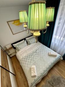 a bedroom with a bed with two lamps on it at Linden Copou in Iaşi