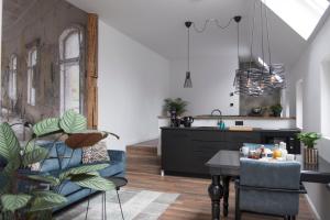 a kitchen and living room with a table and a dining room at B&B Buurvrouw Buurman in Blankenham