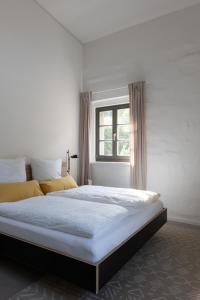a bedroom with a large bed with a window at Schleiferei Zwei, Ferienwohnungen in Sieber