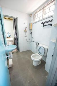 a bathroom with a toilet and a sink at DeLuma-Lovely 4R3B@Kota Permai in Bukit Mertajam