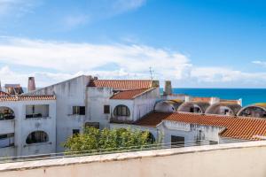 a view of buildings and the ocean at Casa Cerro Branco in Albufeira