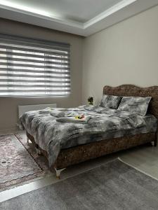 a bedroom with a large bed with a large window at URAZ Suit Otel in Bursa