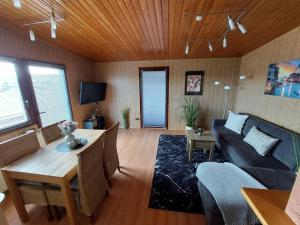 a living room with a couch and a table at Ferienhaus Eifel Nature Dream II in Dockweiler