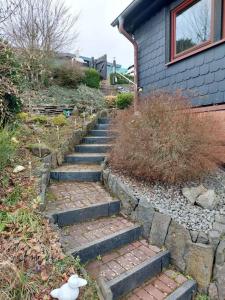 a set of stone stairs next to a house at Ferienhaus Eifel Nature Dream II in Dockweiler