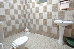 a bathroom with a toilet and a sink at Hillside Spring Valley Resort Masinagudi in Masinagudi
