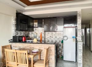 a kitchen with a table and a refrigerator at Isis Guest House in Cairo