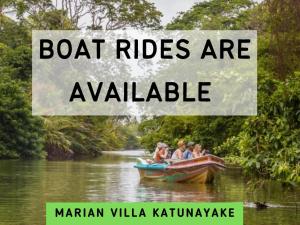 a group of people riding in a boat on a river at Marian Villa in Katunayake