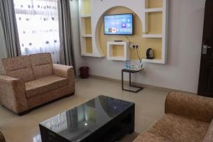 un soggiorno con un divano e una TV di BUNGOMA ROYAL SUITES a Bungoma Altre 6 foto