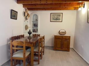 a dining room with a wooden table and chairs at Lemon House in Hydra