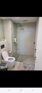a bathroom with a toilet and a glass shower at 2 Bedroom Apartment on Nightfall in Belconnen