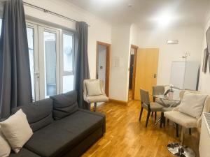 a living room with a couch and a table at Grays apartment in London