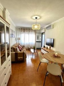 een woonkamer met een bank en een tafel bij Apartamento el Ermitaño in Chipiona