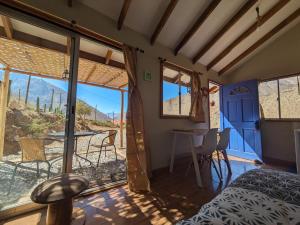 a room with a bed and a table and a window at Cumbres de Alcohuaz in Alcoguaz