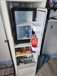 an open refrigerator with its door open at Prime Location Room Stay in Northampton