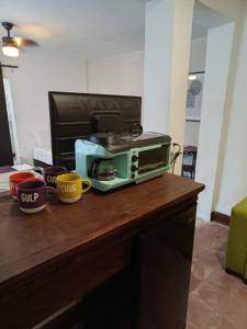 a toaster oven sitting on top of a wooden table at DGM Lofts MTY MN 960 G centro cerca de todo in Monterrey