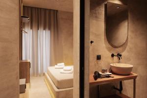 a bathroom with a sink and a mirror at Medusa Luxury Suites in Neos Marmaras