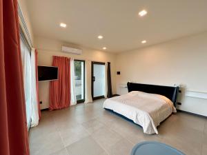 a bedroom with a bed and a tv in it at Cinque Terre Room Rental SULLA VIA in La Spezia