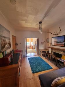a living room with a rug on a wooden floor at Shore Thing - Just a stones throw from the beach in Sandgate