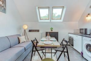 a living room with a couch and a table and chairs at Duplex Moderne à Chennevières in Chennevières-sur-Marne +15 photos