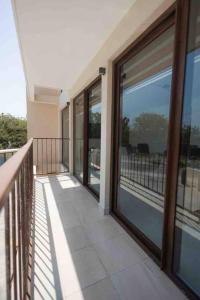 a balcony of a house with sliding glass doors at Departamento Puerta Al Mar in Conchal +22 photos