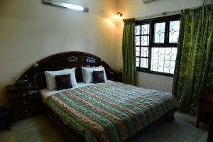 a bedroom with a large bed and a window at Service Apartment in Richmond road in Bangalore