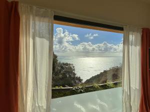 a window with a view of the ocean at Cinque Terre Room Rental SULLA VIA in La Spezia