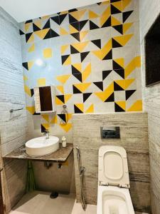 a bathroom with a toilet and a sink at Ultra luxury 5BHK duplex in Kondapur in Kondapur