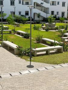 a park with benches in front of a building at Gianna’s Stays in Mombasa