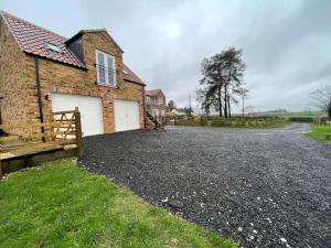 a driveway in front of a brick house at Roseberry View Barn, Northallerton in Northallerton