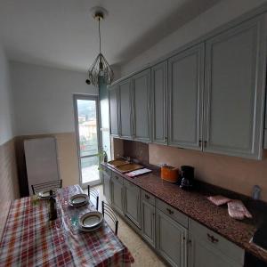 a kitchen with a table in the middle of it at La terrazza sugli ulivi in Toscolano Maderno