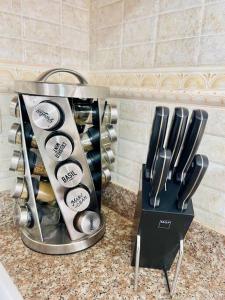 a kitchen counter with a container of utensils at Super Cozy n´Confortable apart. in Ensanche Los Minas