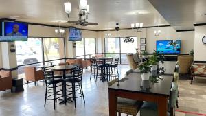a restaurant with tables and chairs and a bar at THE PARAGON of Golden Isles in Brunswick
