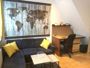 a living room with a couch and a desk with a world mural at Citadelle Vauban, T2 l'encyclopédie in Lille