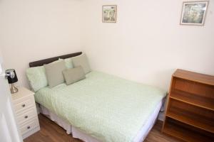 a small bedroom with a bed with a nightstand at Lily's Place in Cleethorpes