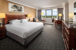 a hotel room with a large bed and a desk at Hilton Short Hills in Short Hills