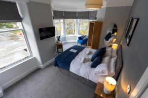 a bedroom with a bed and a large window at The Crossing Bed and Breakfast in Kingussie