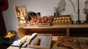 uma mesa com cestas de pão e outros alimentos em ibis budget Saint-Brieuc Yffiniac em Yffiniac