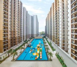 an overhead view of a swimming pool with buildings at Easytrip in Lucknow