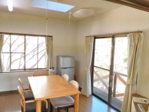 a dining room with a table and chairs and two windows at Ten Ten Go Shibu Kawa - Vacation STAY 41956v in Ono