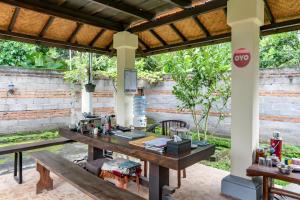 an outdoor office with a table and benches at Calm Haven Villa with Amabela Garden Lovina Beach in Lovina