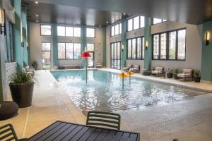 a large swimming pool in a building with windows at Embassy Suites By Hilton Gatlinburg Resort in Gatlinburg