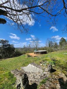a building on top of a green field at Maison de campagne, au calme. in Carlux