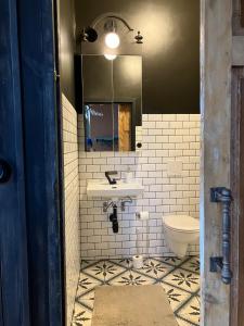 a bathroom with a sink and a toilet at Stationshus apartment in Hallstahammar +13 photos