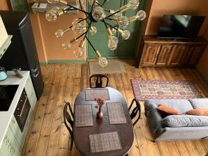 a dining room with a table and a couch at Stationshus apartment in Hallstahammar