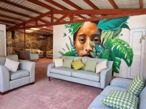 a large mural of a man with leaves on a wall at Central Hostel San Sebastian in Antigua Guatemala