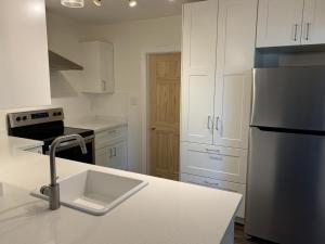 a kitchen with a sink and a refrigerator at Great family choice in Whitby