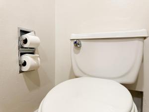 a white toilet in a bathroom with two rolls of toilet paper at Courtyard by Marriott Villahermosa Tabasco in Villahermosa
