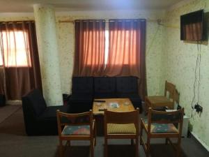 a living room with a couch and a table and chairs at Dana INN in At-Tafilah