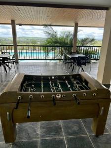 a large pool table in a room with a balcony at Flat Villa Monte Castelo in Bezerros
